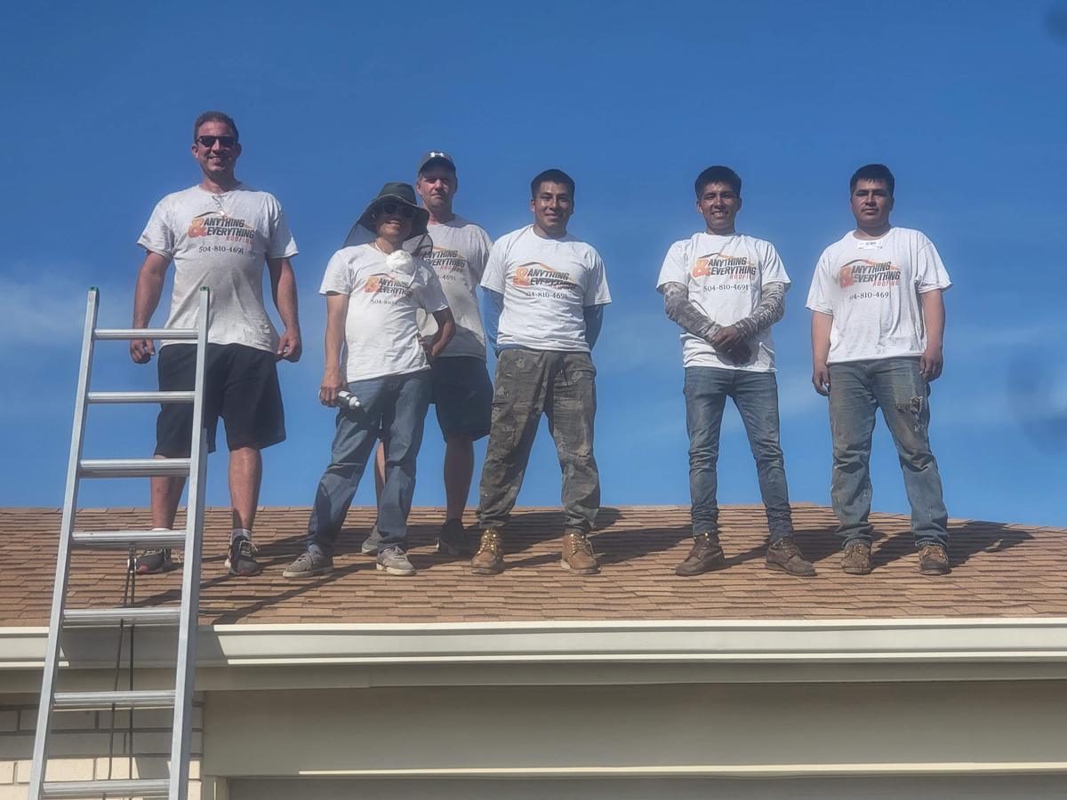 Anything and Everything Roofing crew standing on a shingle roof