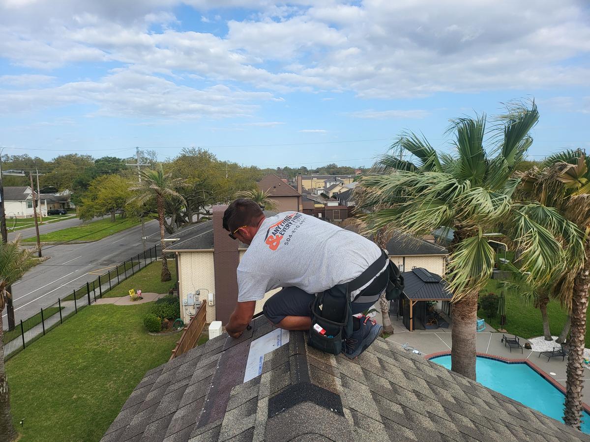 Roofer installing ridge cap shingles