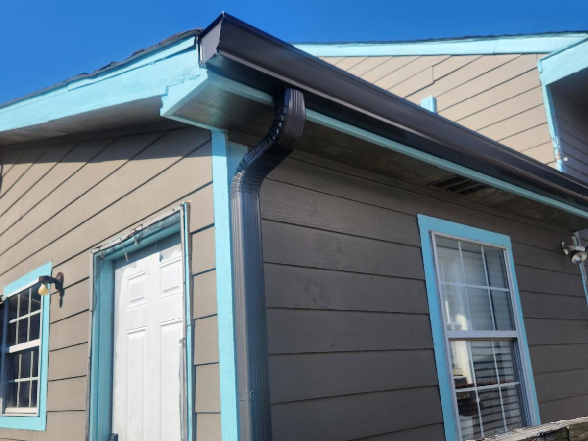 Dark bronze seamless gutter and downspout on a New Orleans home